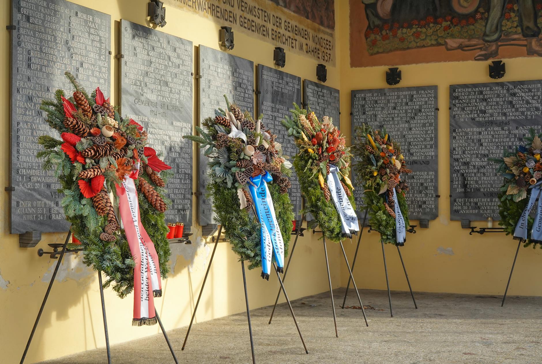 Floral wreaths in Mondsee, Austria at a historical memorial site.