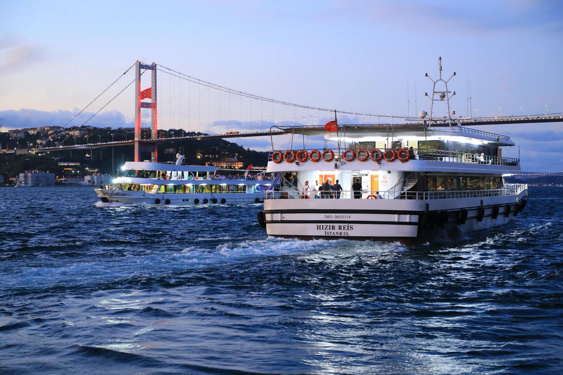 Ferries sail on the Bosphorus with the July 15 Martyrs Bridge in the background, Istanbul, Turkey.